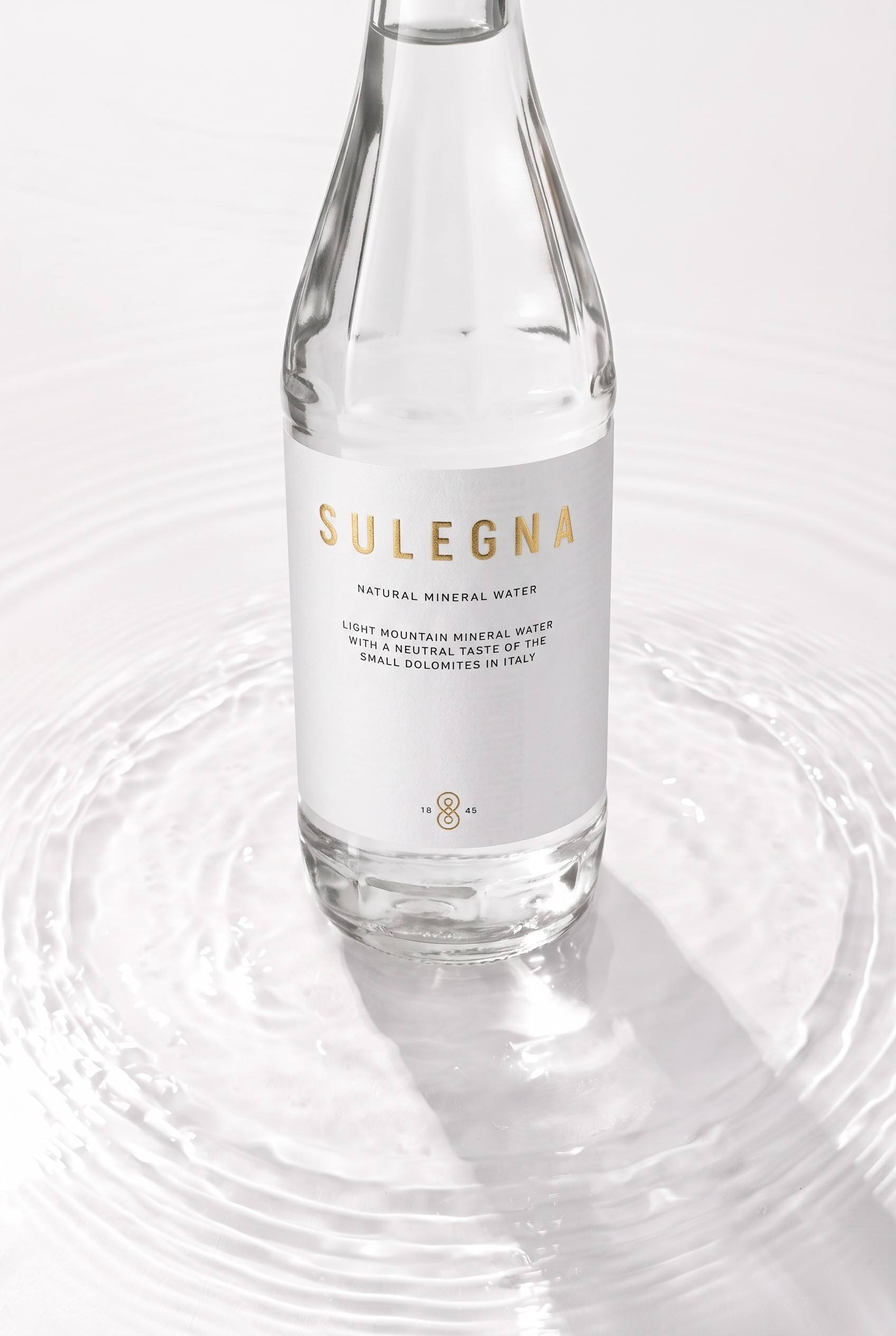 Macro of glass texture and bottle shoulder with light refraction